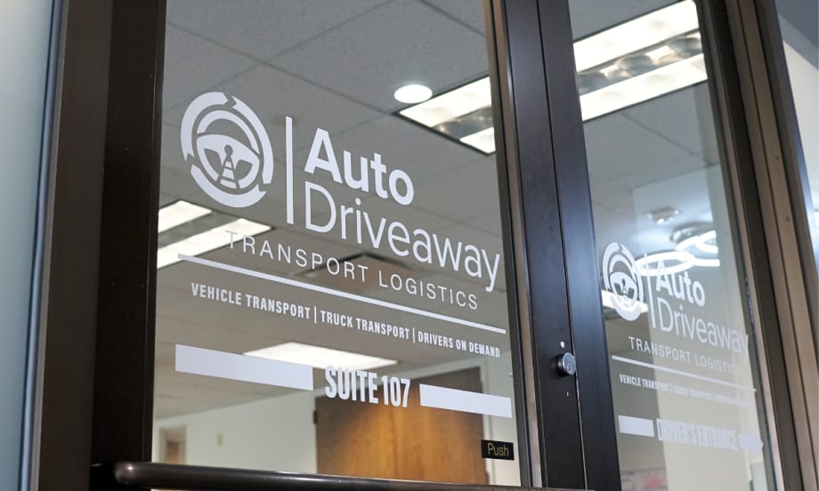 The business front to Auto Driveway with the company logo on the door.