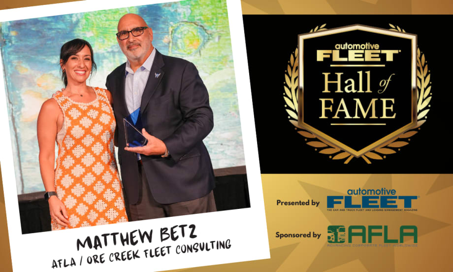 A black and gold graphic with an emblem for "Fleet Hall of Fame" and a polaroid element with a picture of Betz and his daughter.