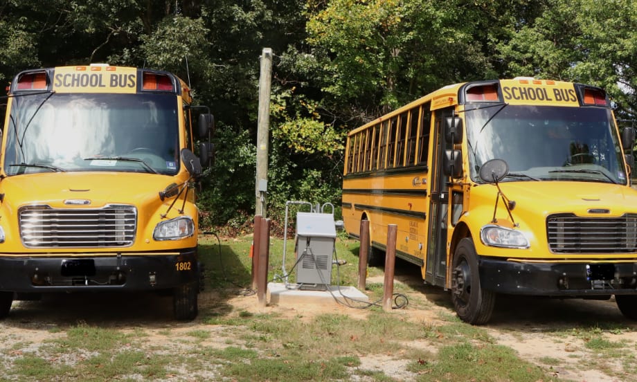 Two school buses parked next to each other.