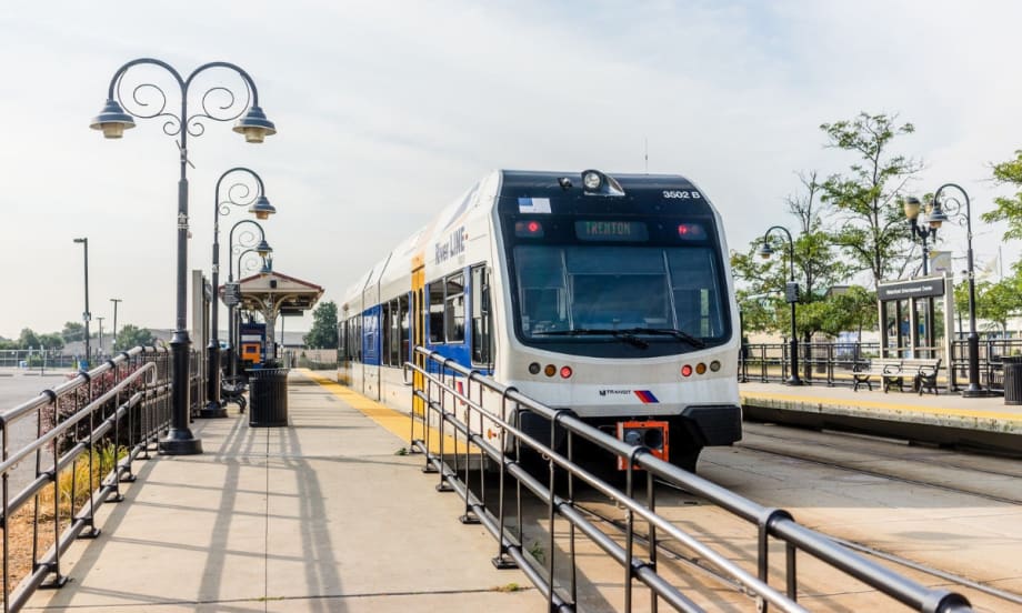 An NJ TRANSIT River LINE rail vehicle at a station.