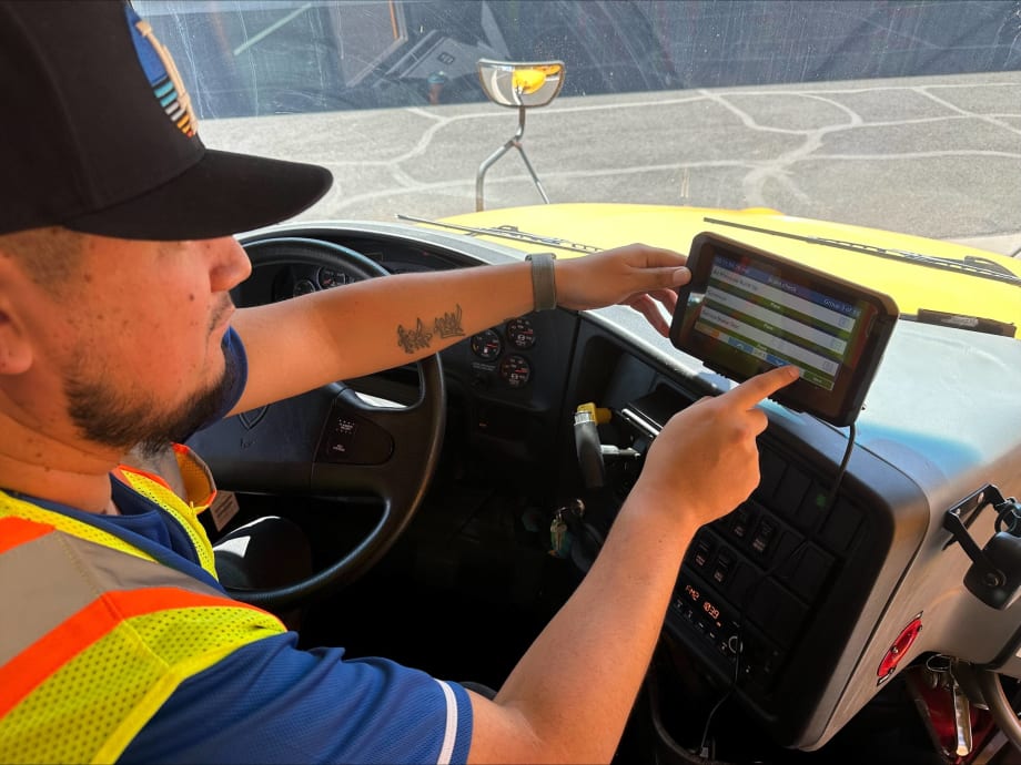 A driver managing his routing tablet