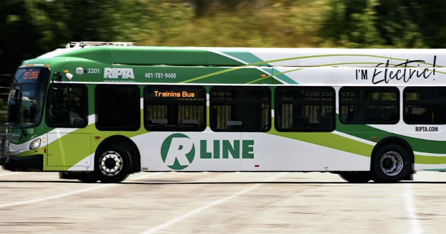 A green and white Rhode Island Public Transit Authority electric bus.