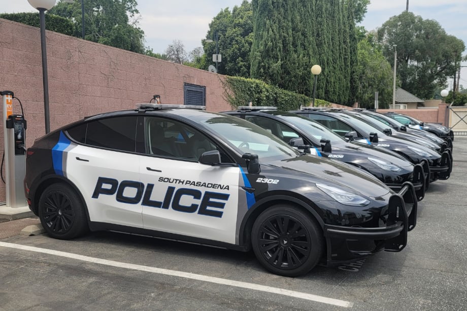 Tesla Model Ys and 3s are shown lined up in a parking lot. They are upfitted with police equipment and have South Pasadena Police decals on them.