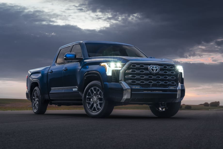A blue 2022 Toyota Tundra is shown with its headlights on.