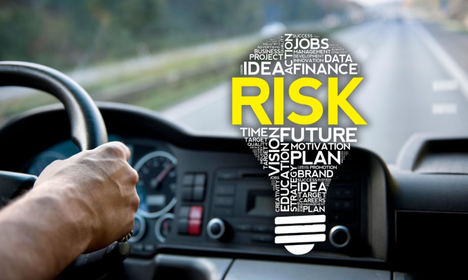 truck driver facing road with risk lightbulb overlaid.