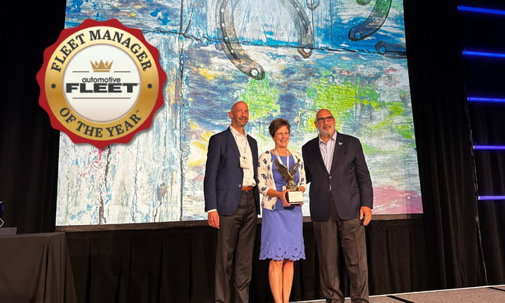 Fleet manager receives award on stage.