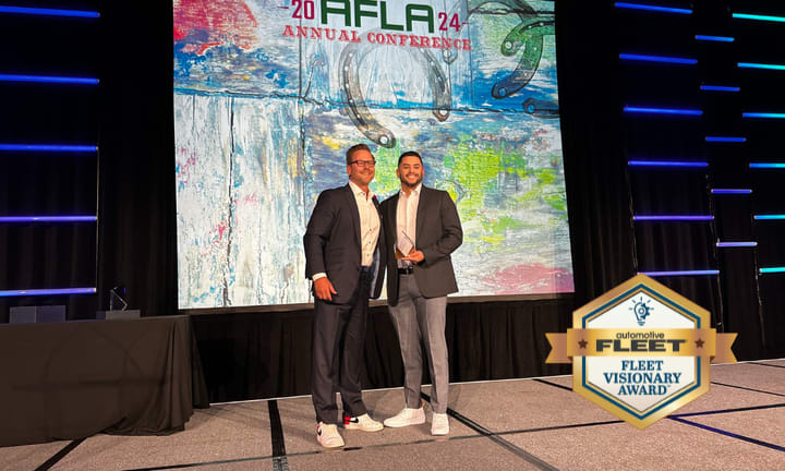 Fleet manager receives award on stage.