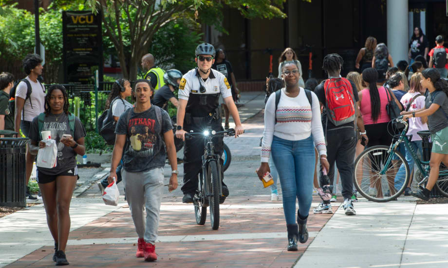 An officer rides an e-bike through the campus of Virginia Commonwealth University.