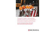 Cover image for a BOK Financial report titled “Timing the market: How avoiding volatility entirely can hurt long-term reinsurance program performance.” The image shows several road construction barricades with flashing amber warning lights lined up in a nighttime work zone. Beneath the image, red text explains that avoiding volatility can mean falling behind inflation and missing market rebounds that drive long-term surplus growth. The BOK Financial logo appears at the bottom right.