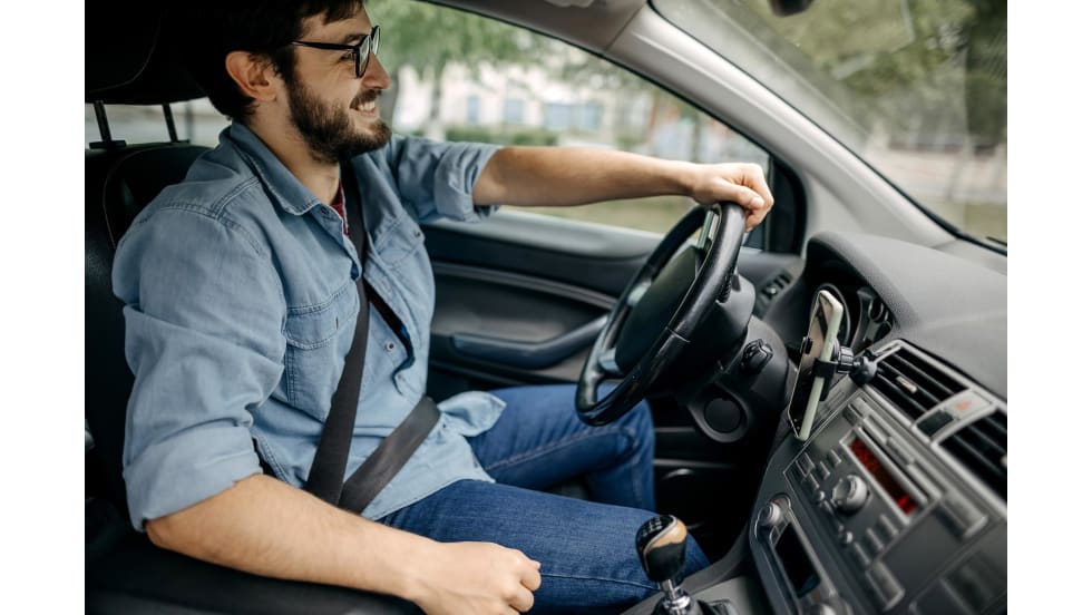 man smiling while driving