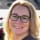 woman with glasses smiling