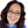 woman with glasses smiling