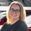 woman with glasses smiling